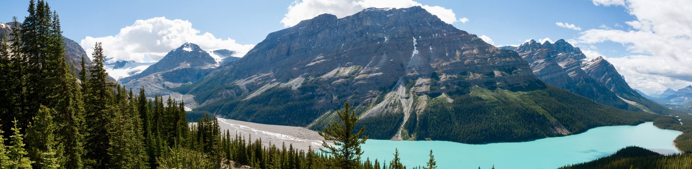 A glacial lake surrounded by green mountains.