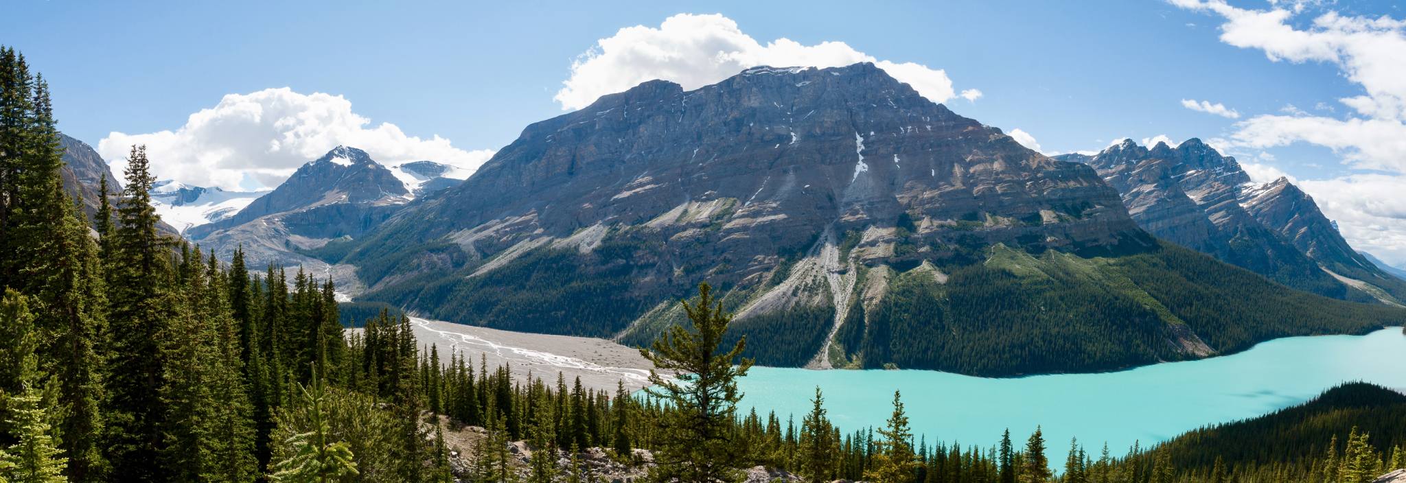 A glacial lake surrounded by green mountains.