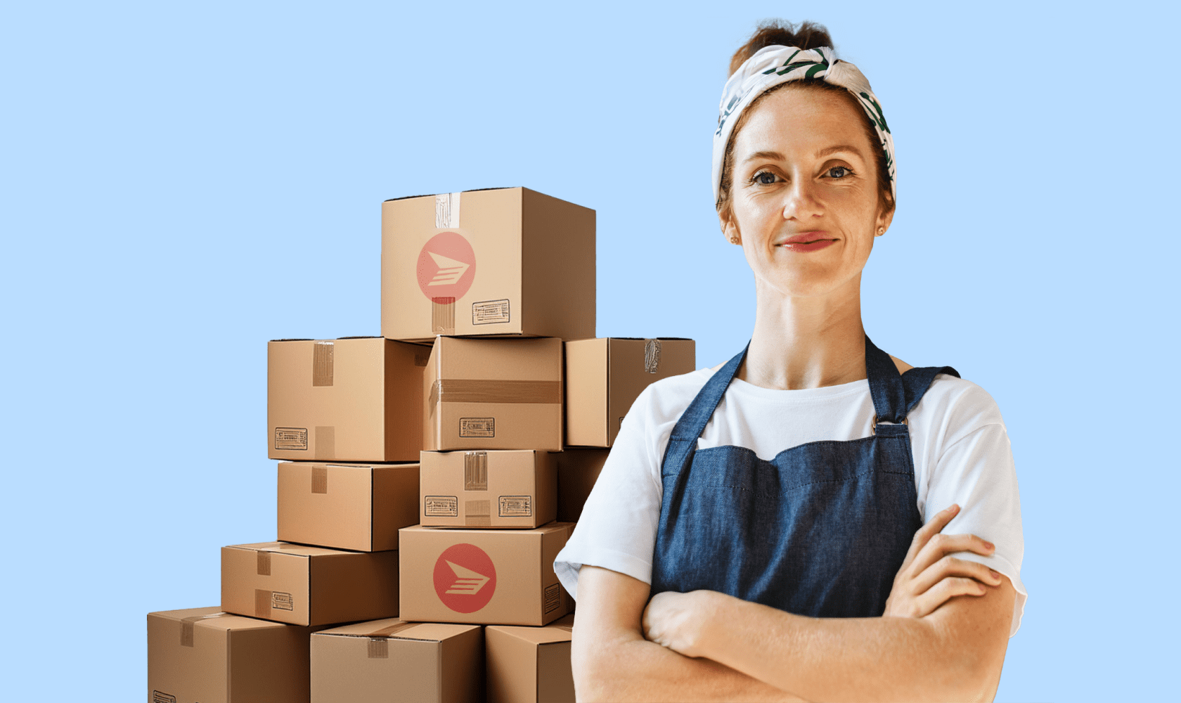 A woman crosses her arms and smiles. She wears a headband and an apron. A stack of shipping boxes with Canada Post’s logo are in the background.